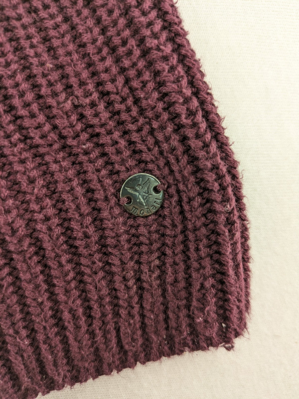Monari burgundy knit jumper with standing collar, ribbed texture, and raglan sleeves.