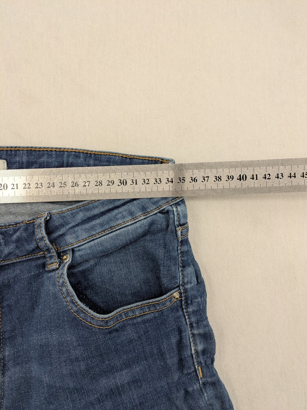 H&M blue skinny jeans with distressed details and comfortable stretch denim material.