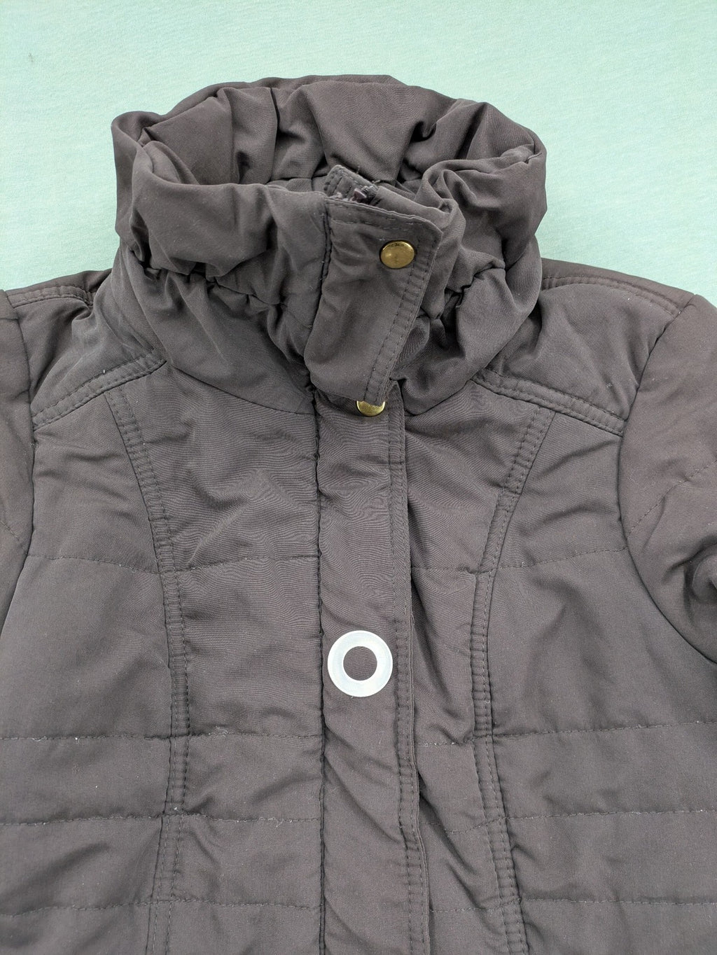 Vero Moda grey quilted jacket with high funnel neck and zippered pockets.