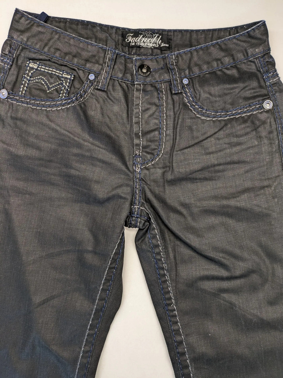 Fadnoble grey straight jeans with button fly and contrasting stitching details.