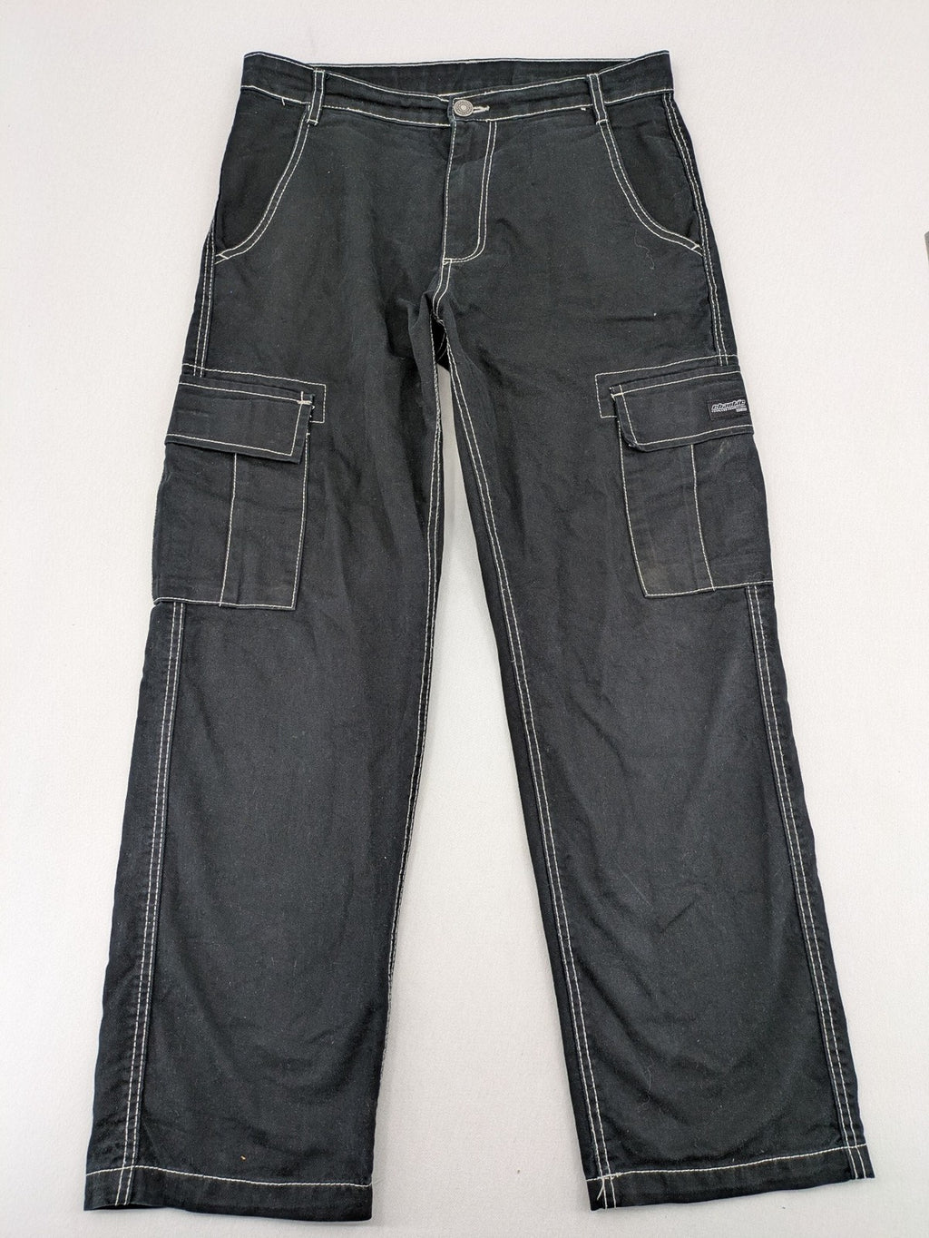 FSBN black baggy cargo pants with white contrast stitching and multiple pockets.