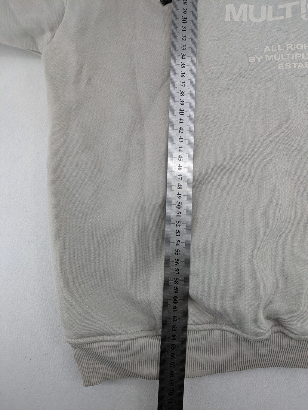 Multiply grey zip-through hoodie with embroidered logo and large "MLTPLY" print on back.