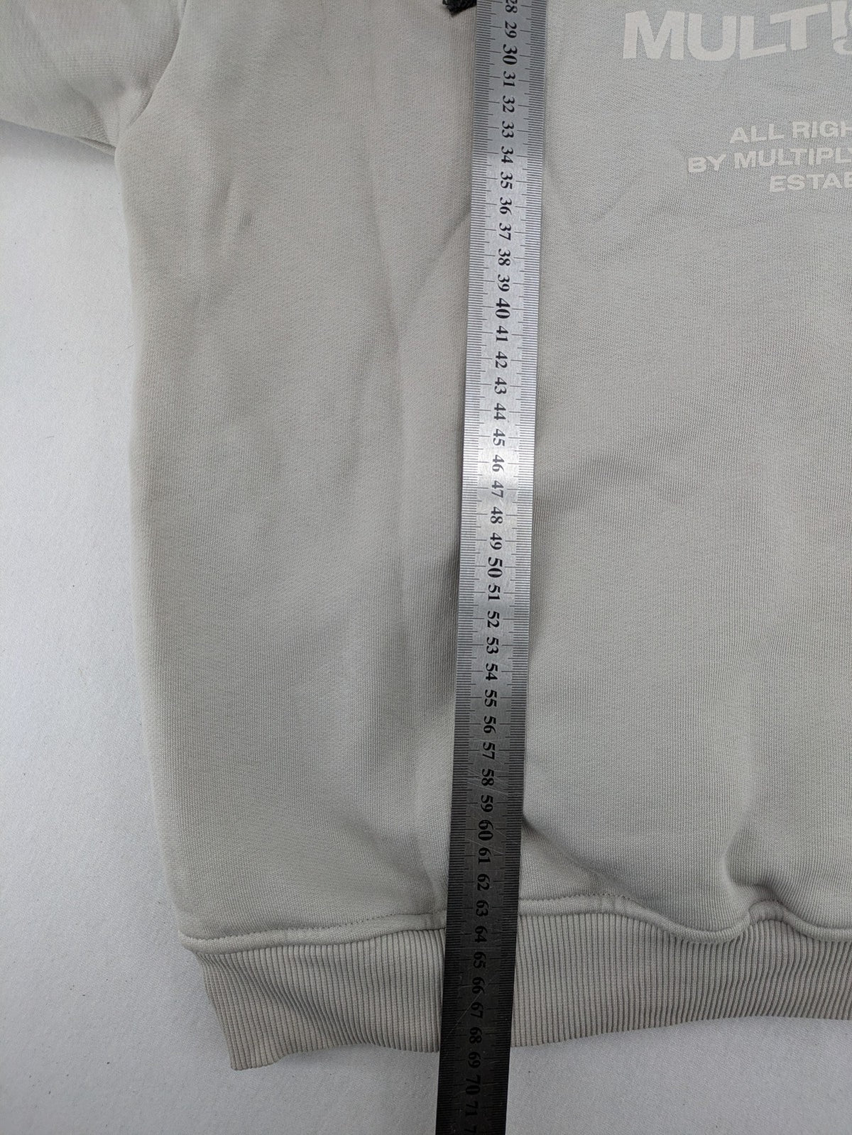 Multiply grey zip-through hoodie with embroidered logo and large "MLTPLY" print on back.
