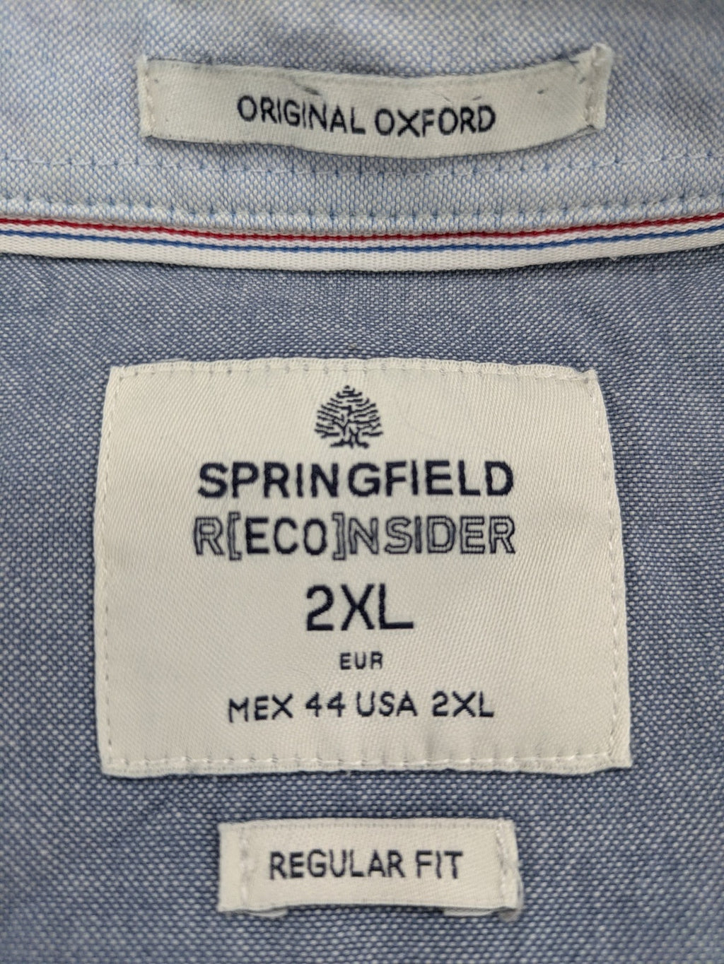 Springfield blue Oxford shirt with button placket and subtle logo embroidery.