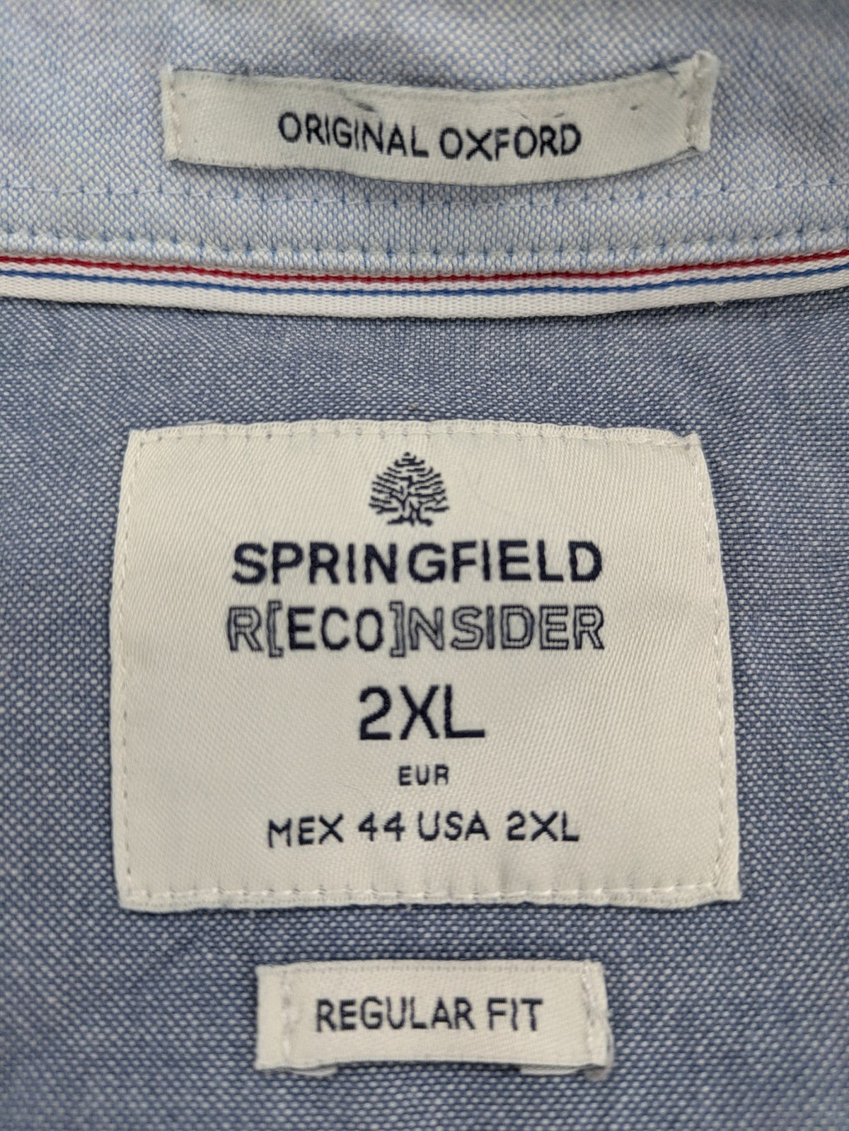 Springfield blue Oxford shirt with button placket and subtle logo embroidery.
