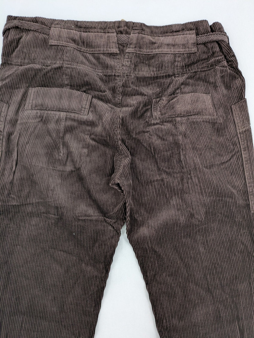 Alma & Lovis brown cord pants with elastic waistband, drawstring, and front patch pockets.