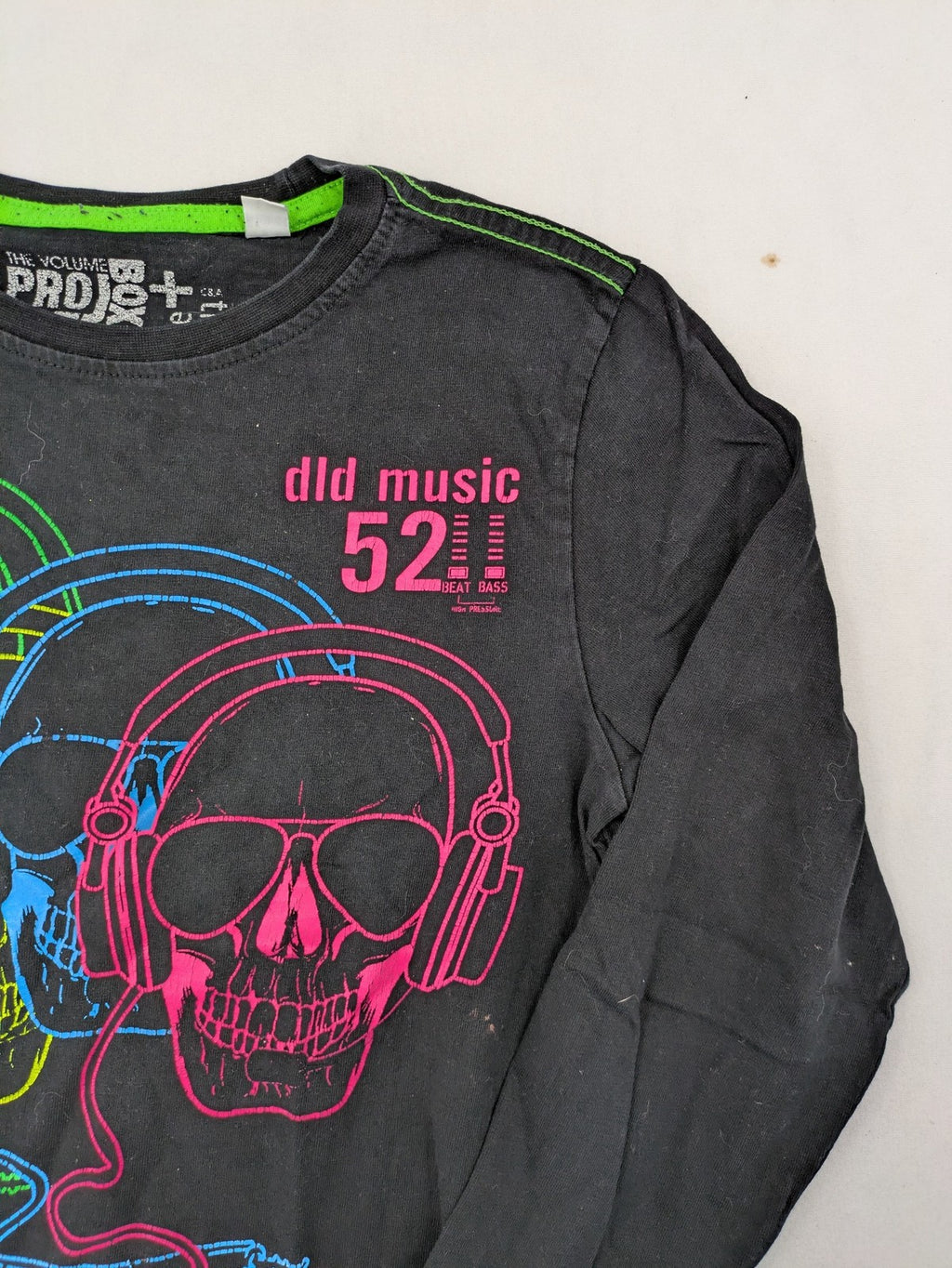 here there pink long sleeve shirt neon skull graphic with headphones and green contrast stitching