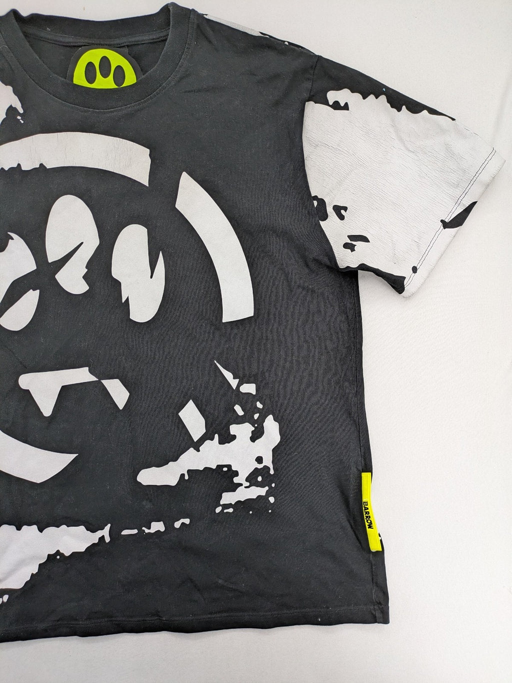 Barrow grey t-shirt with large black and white smiley graphic print and logo patch.