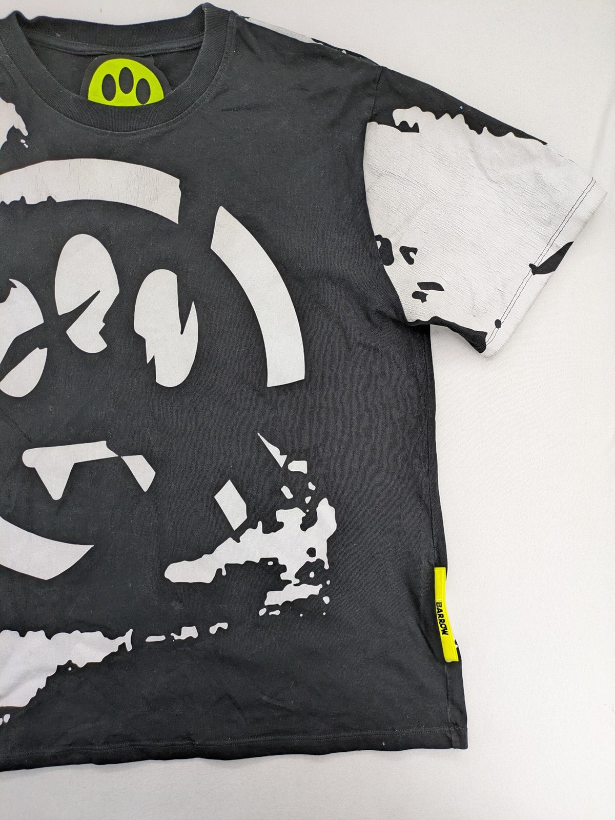 Barrow grey t-shirt with large black and white smiley graphic print and logo patch.