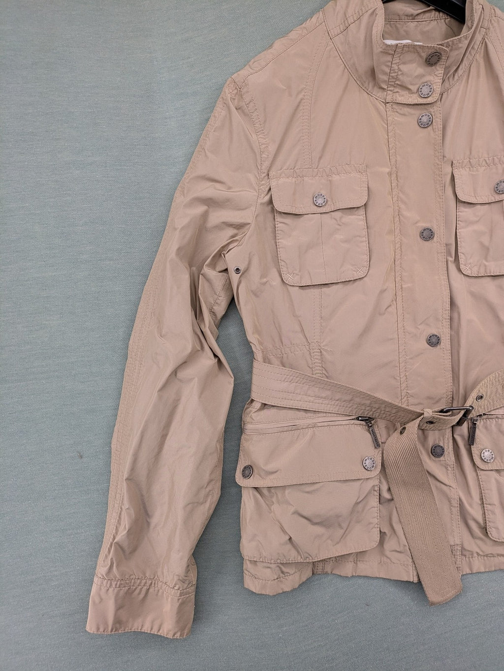 MORE & MORE beige field jacket with belt, four pockets, and standing collar.