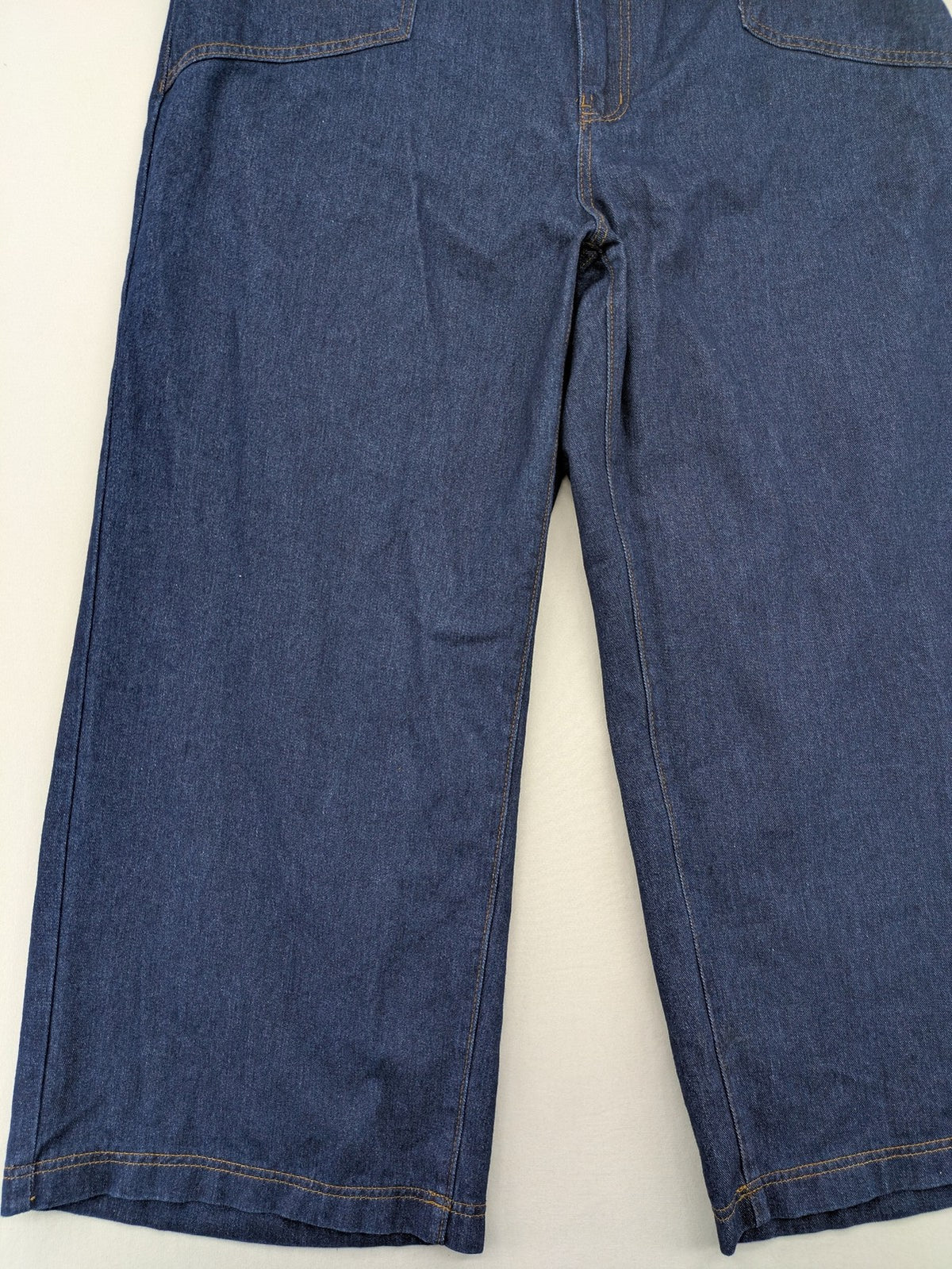 Emery Rose pink culotte pants with wide legs, double button closure, and soft denim blend.
