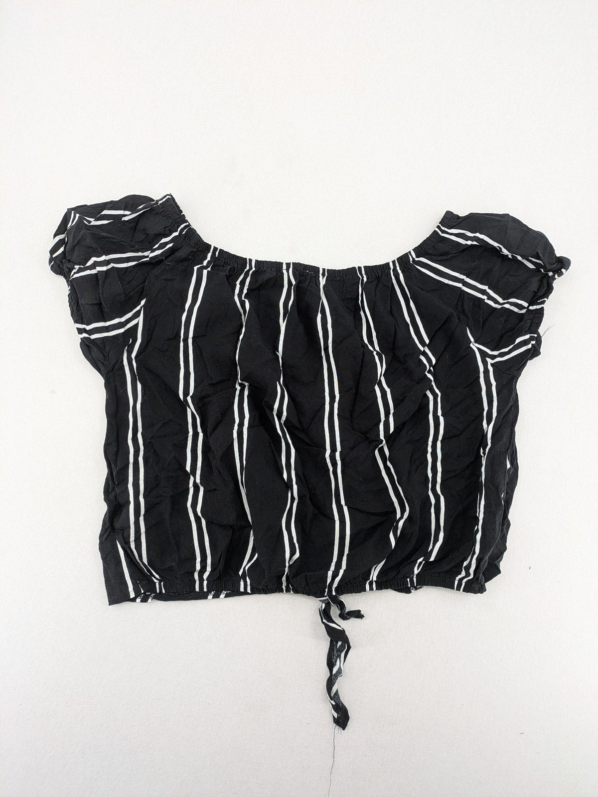 Hailys black and white striped crop top with front tie and off-shoulder design.