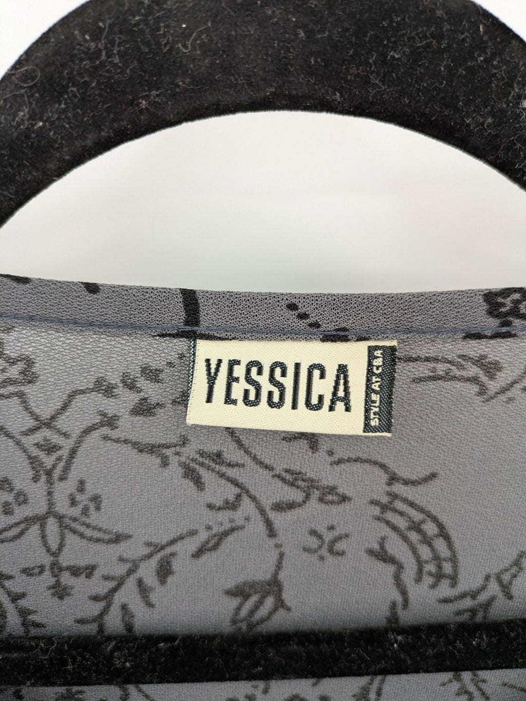 Yessica grey black floral pattern tunic top with round neckline and long sleeves.