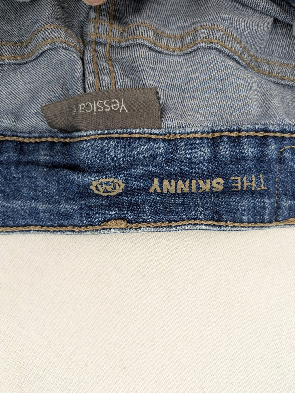Yessica blue skinny jeans with two-tone side stripe and classic five-pocket design.