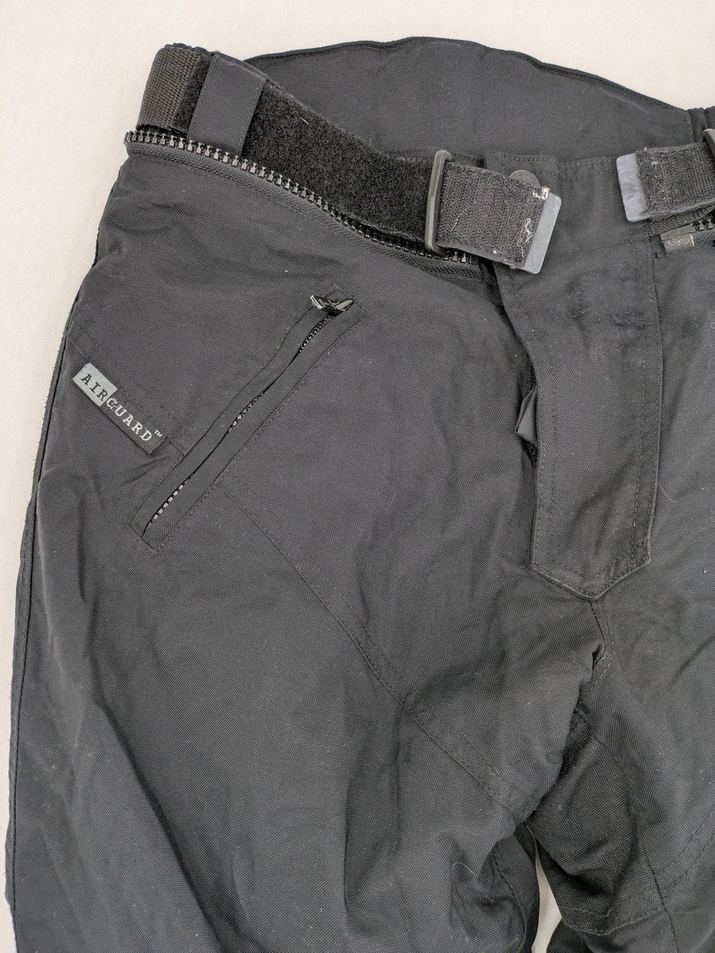 iXS black chaps with grey accents, waterproof textile, adjustable belt, reinforced knees.