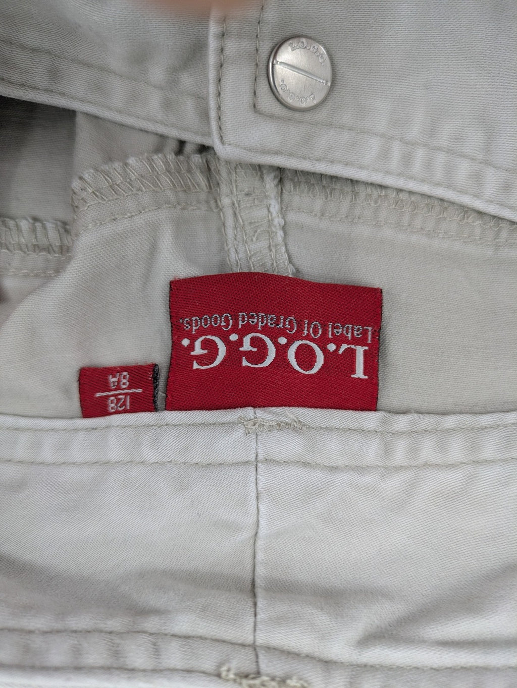H&M L.O.G.G beige bootcut pants with double button closure and stretch cotton material.