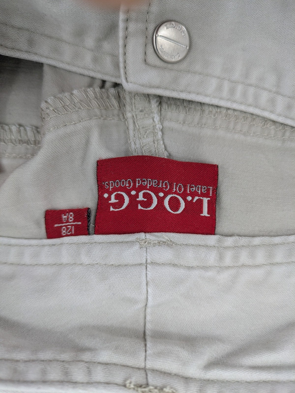 H&M L.O.G.G beige bootcut pants with double button closure and stretch cotton material.
