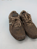 Dockers brown sneakers with subtle light brown and blue accents, lace-up design.