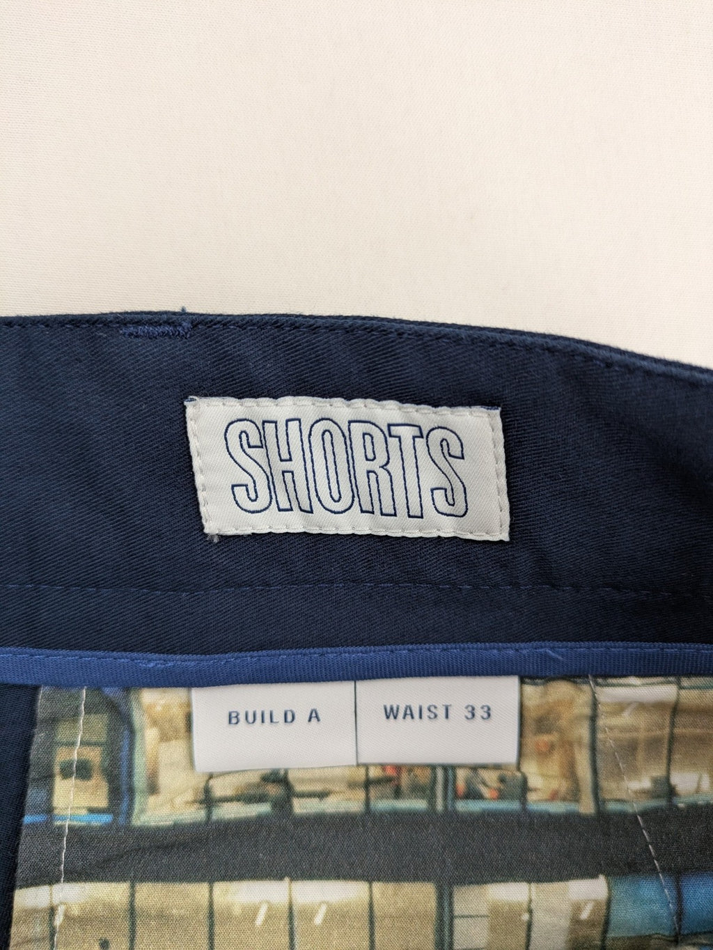 Spoke navy chino shorts flat front with unique printed pocket lining.