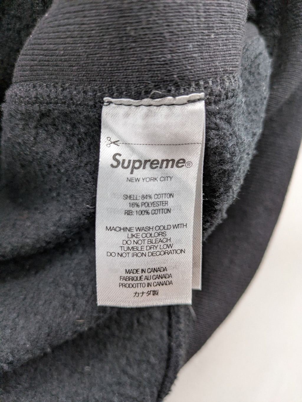Supreme grey hoodie with embroidered small box logo, kangaroo pocket, and ribbed cuffs.