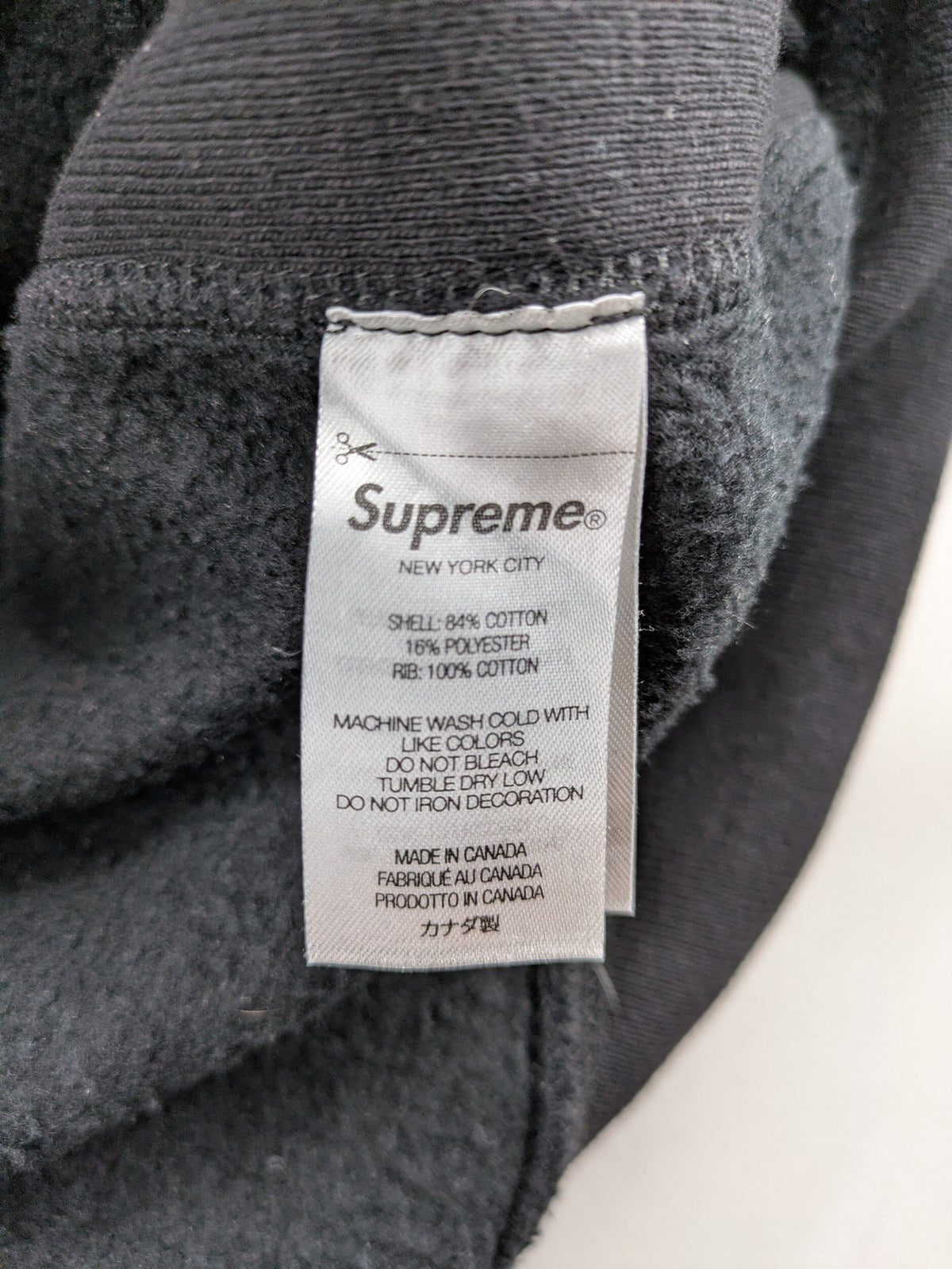 Supreme grey hoodie with embroidered small box logo, kangaroo pocket, and ribbed cuffs.