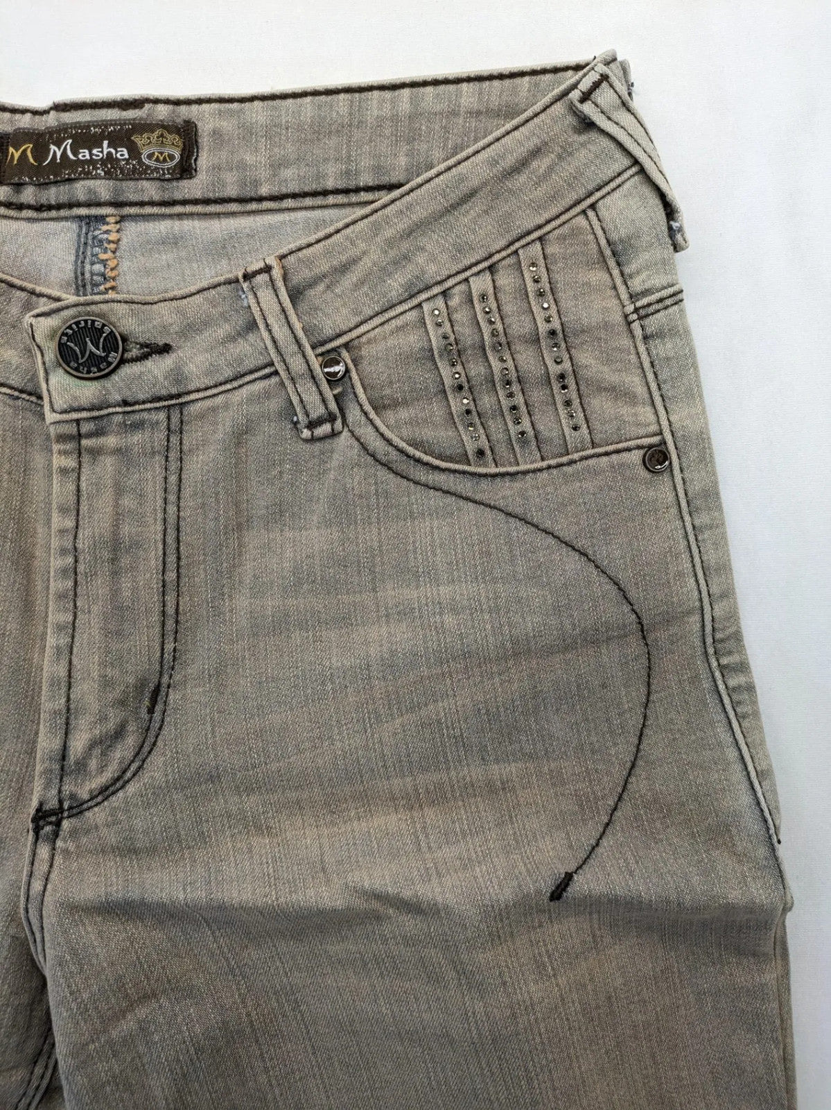 Masha khaki straight jeans with rhinestone embellishments and decorative stitching.
