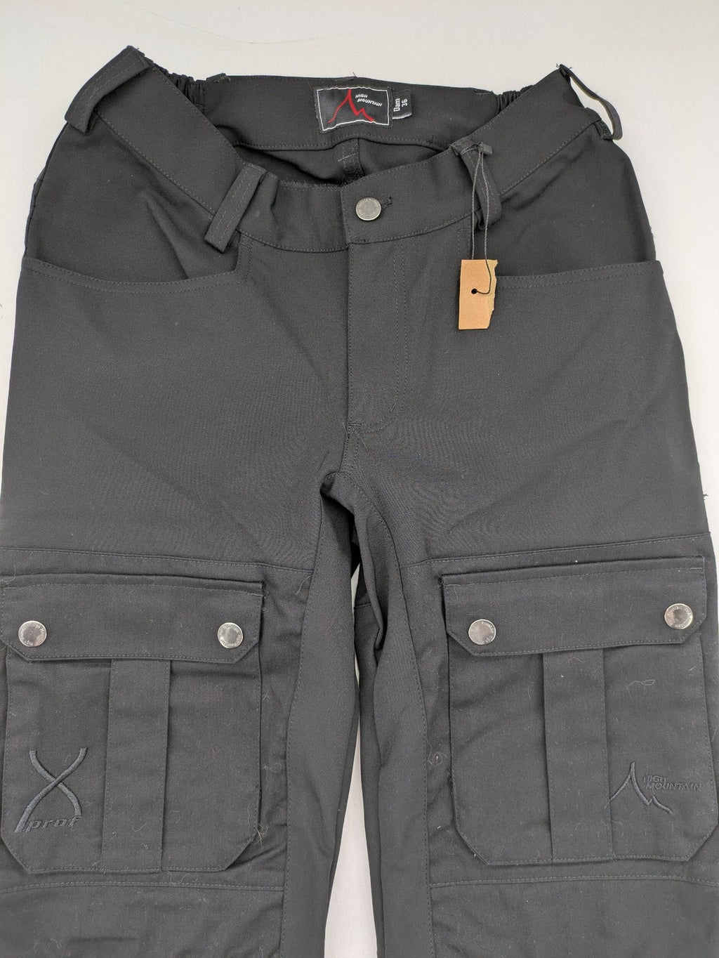 High Mountain black cargo pants with multiple pockets and durable stretch material.