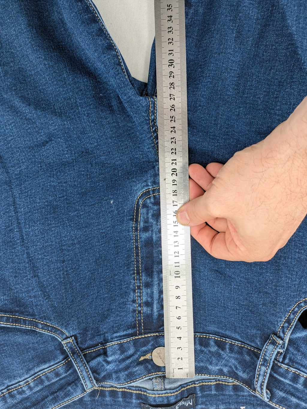 Miss Good blue straight jeans with 5-pocket design and decorative metal accent.