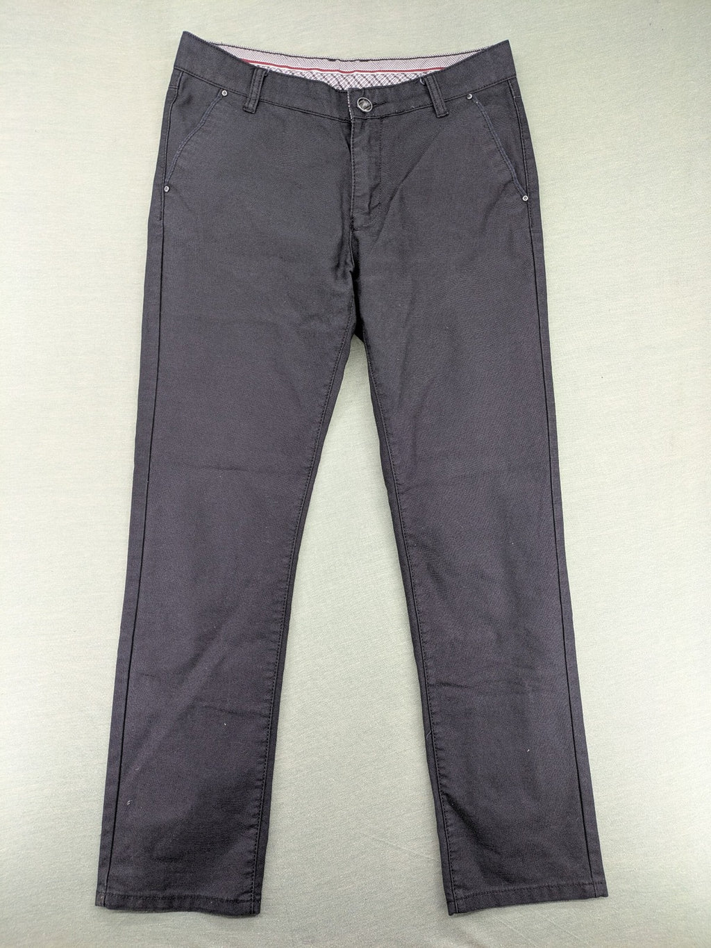Rooney grey chino pants with checkered waistband and buttoned back pockets.