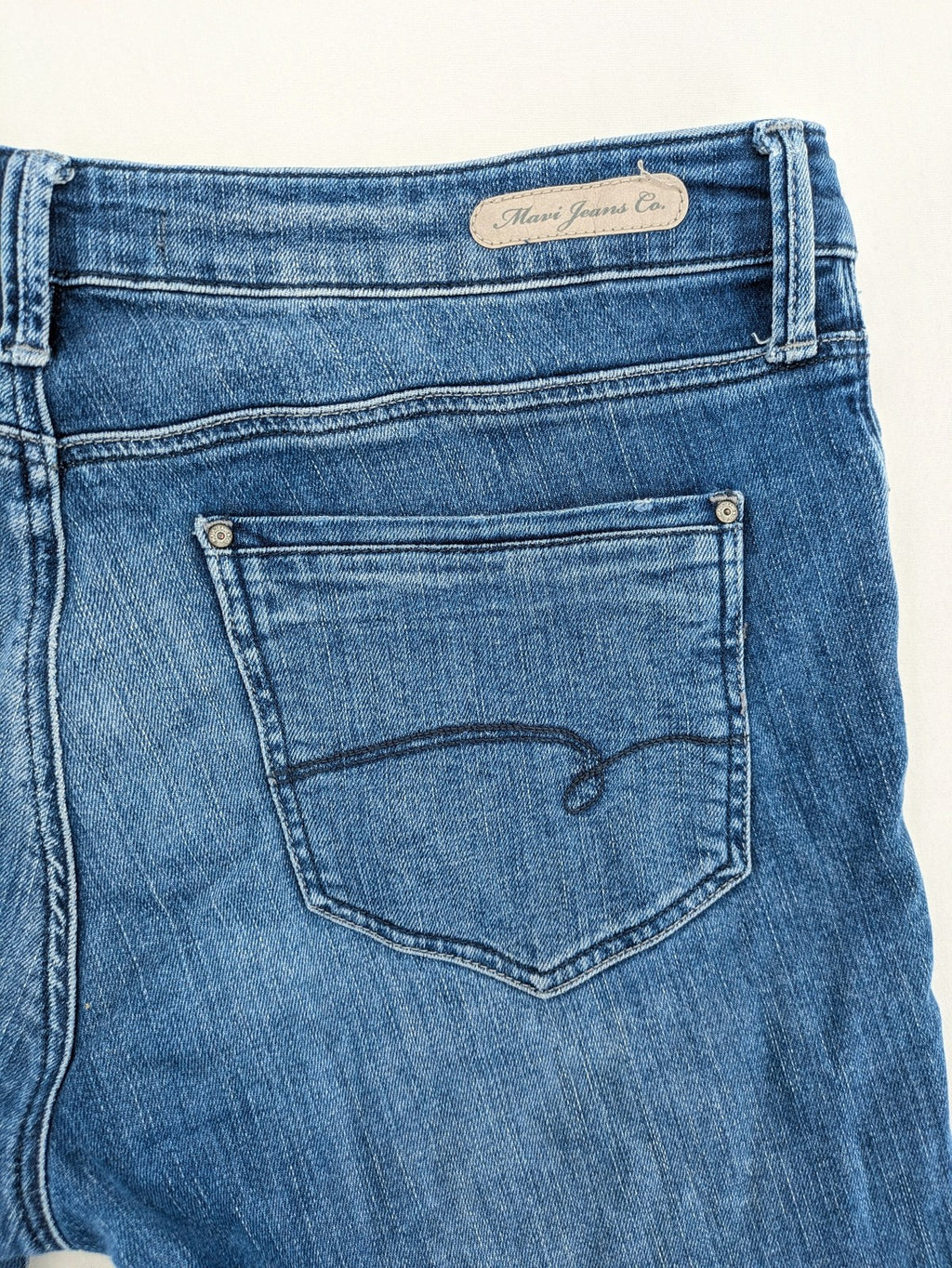Mavi blue straight leg jeans with classic 5-pocket styling and medium wash.