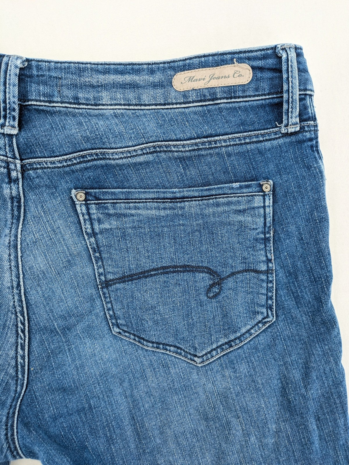 Mavi blue straight leg jeans with classic 5-pocket styling and medium wash.