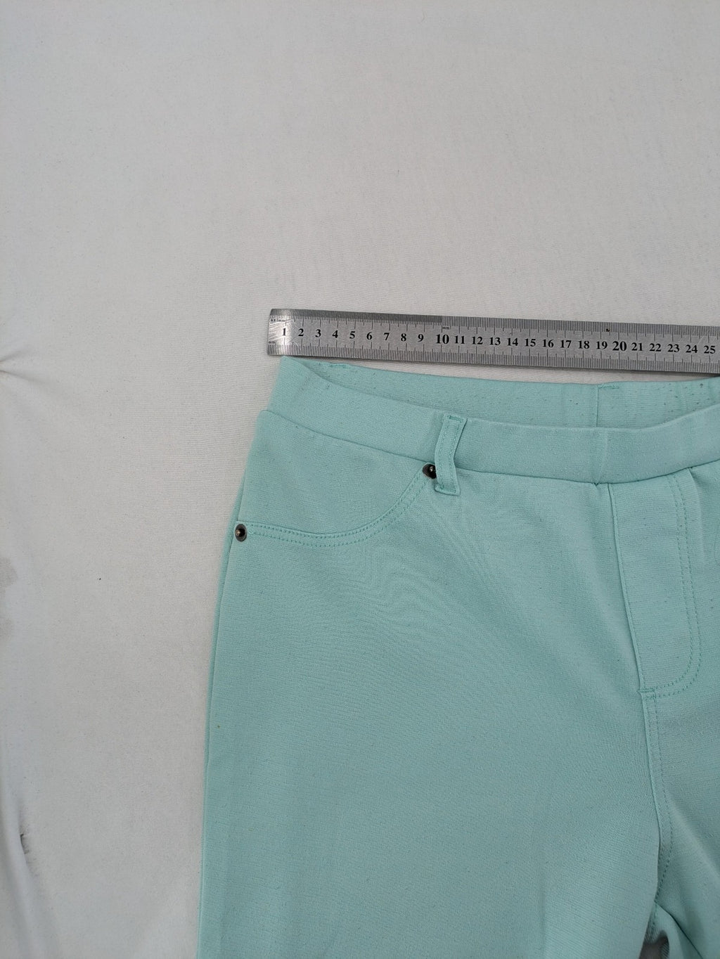 Dito green treggings with pull-on design, front pockets, and belt loops.