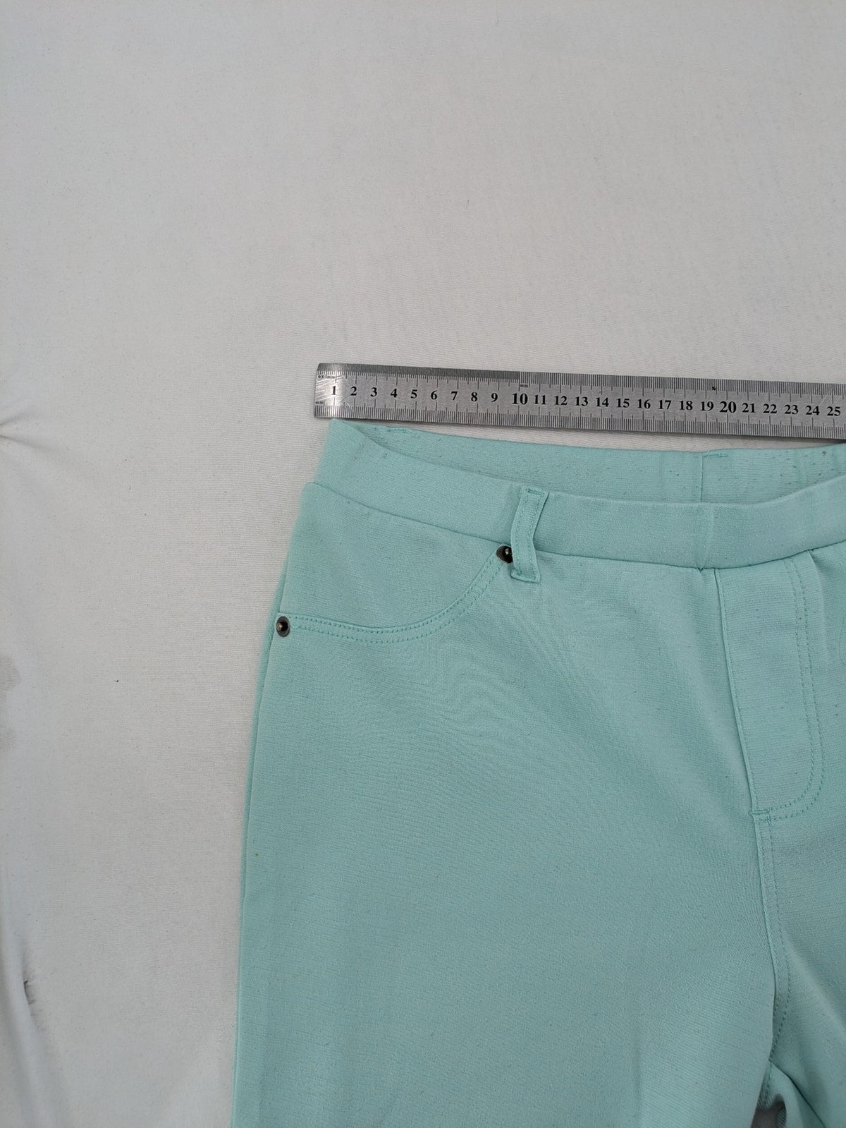 Dito green treggings with pull-on design, front pockets, and belt loops.