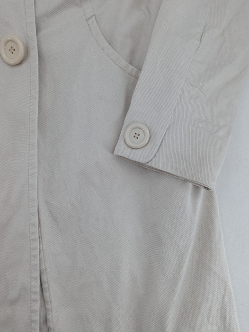 H&M beige trench coat size 38, classic design with button closure and striped lining.
