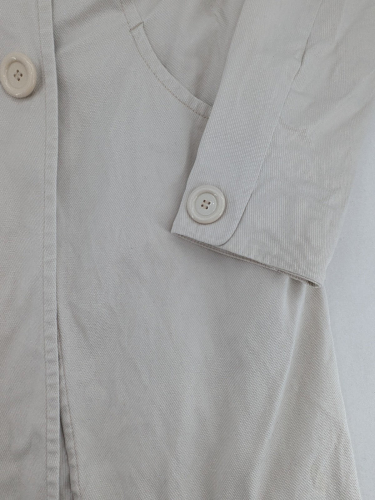 H&M beige trench coat size 38, classic design with button closure and striped lining.