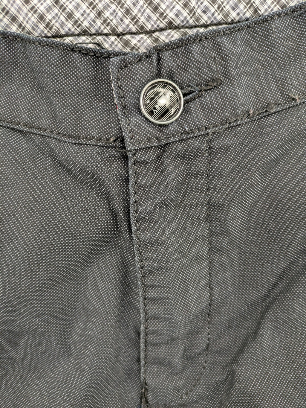 Rooney grey chino pants with checkered waistband and buttoned back pockets.