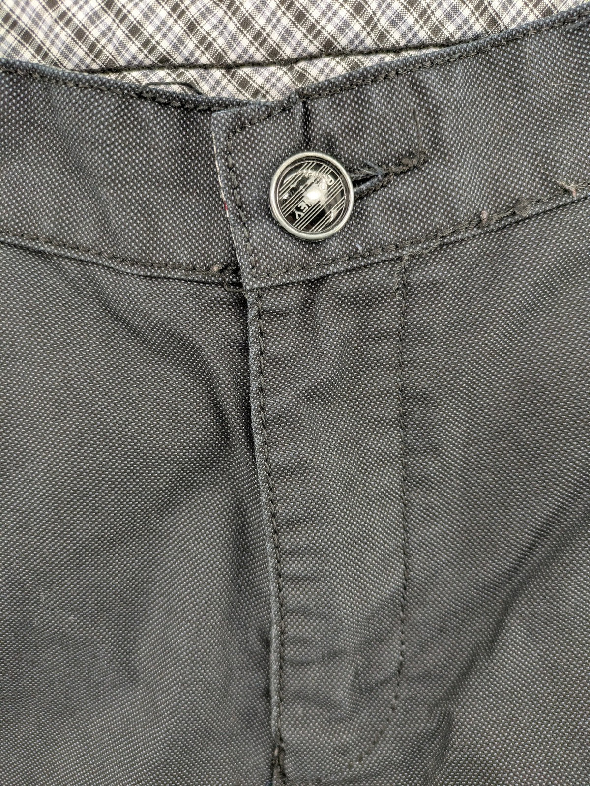 Rooney grey chino pants with checkered waistband and buttoned back pockets.