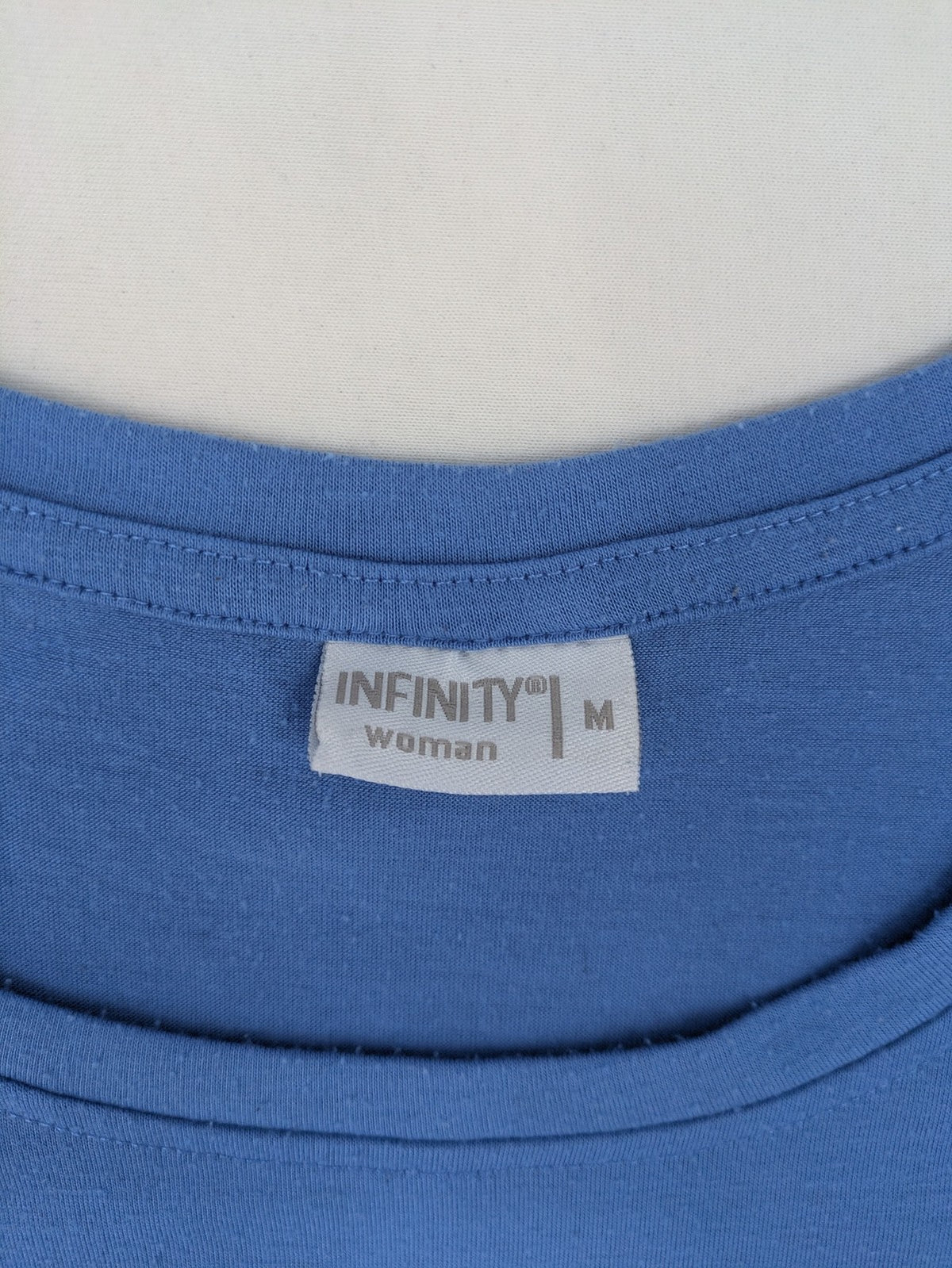Infinity blue T-shirt dress A-line cut with playful flutter sleeves and soft stretch fabric.