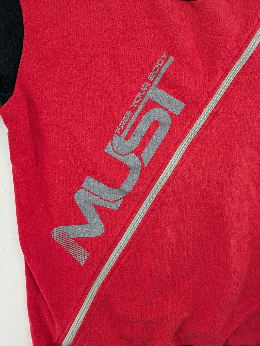 Boystar vintage turtle neck jumper red black colorblock with "MUST FREE YOUR BODY" graphic.