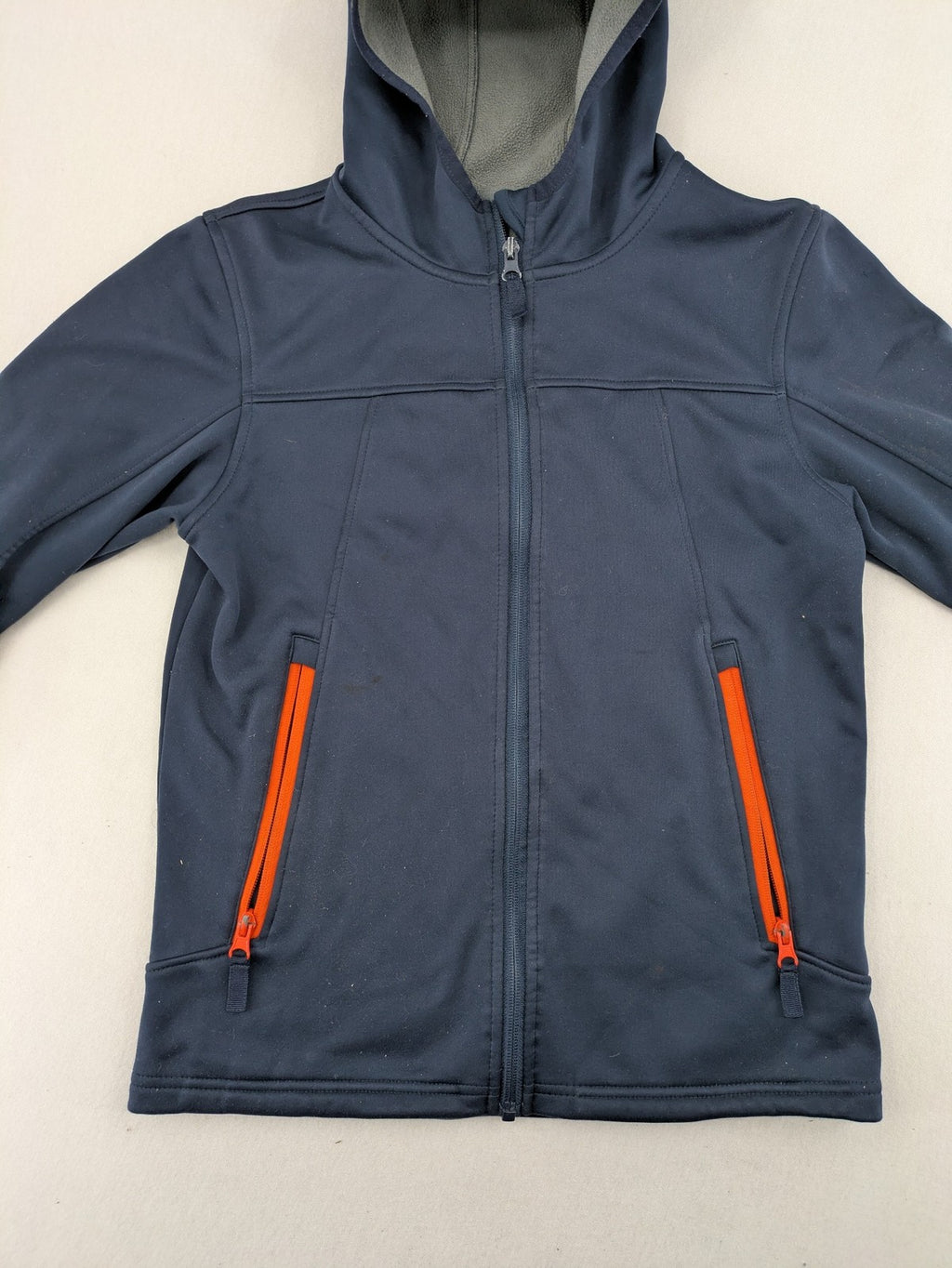 Crane navy softshell jacket with fleece lining, full zip, orange accent zippers.