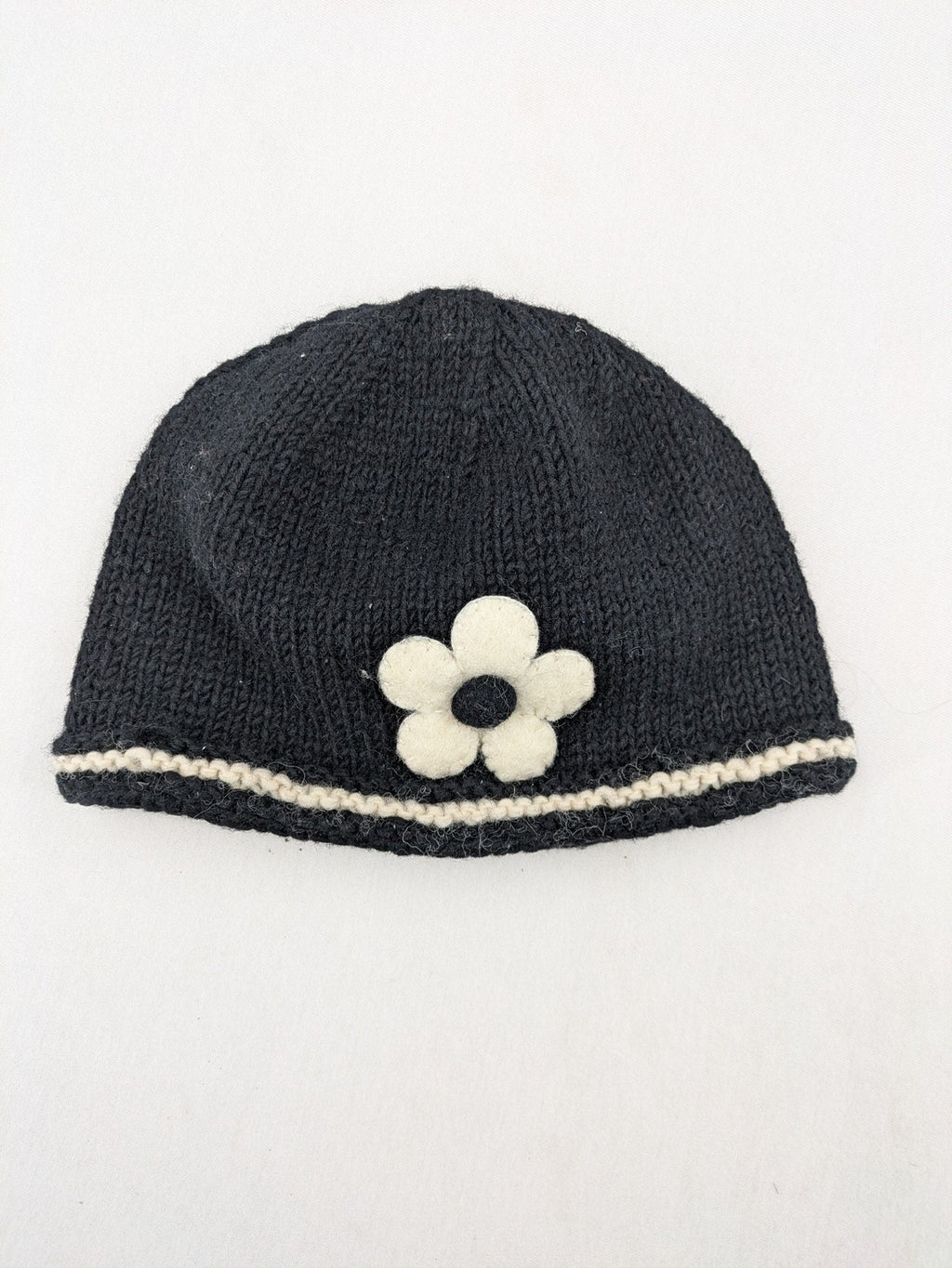 Fischers Textil multi beanie hand-knitted wool with fleece lining and floral appliqué.
