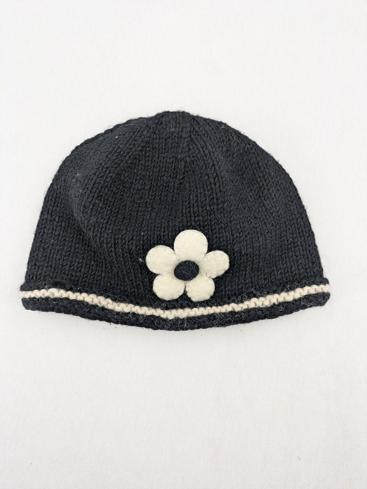 Fischers Textil multi beanie hand-knitted wool with fleece lining and floral appliqué.