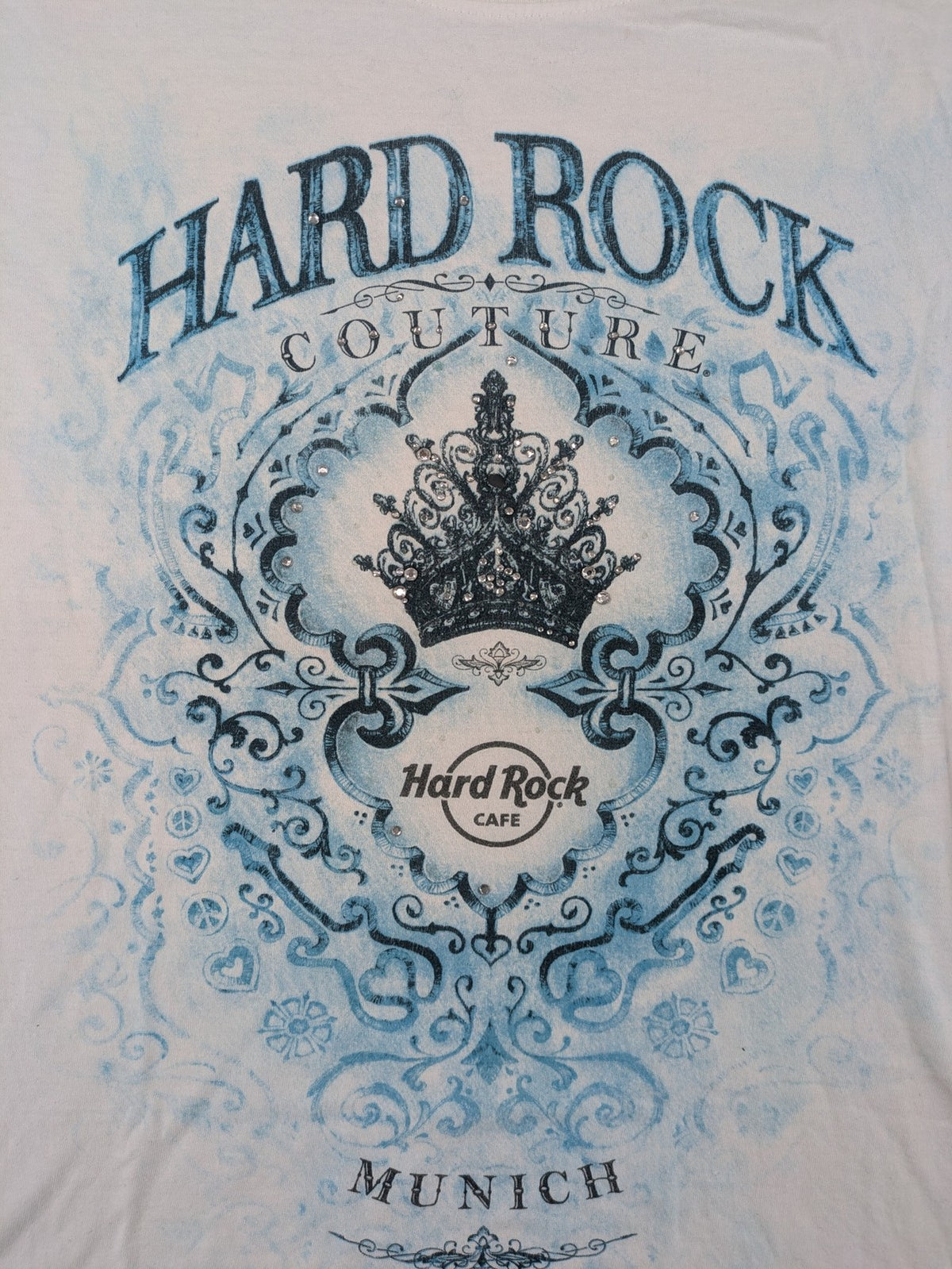 Hard Rock Cafe blue and white T-shirt with crown graphic and rhinestone accents.