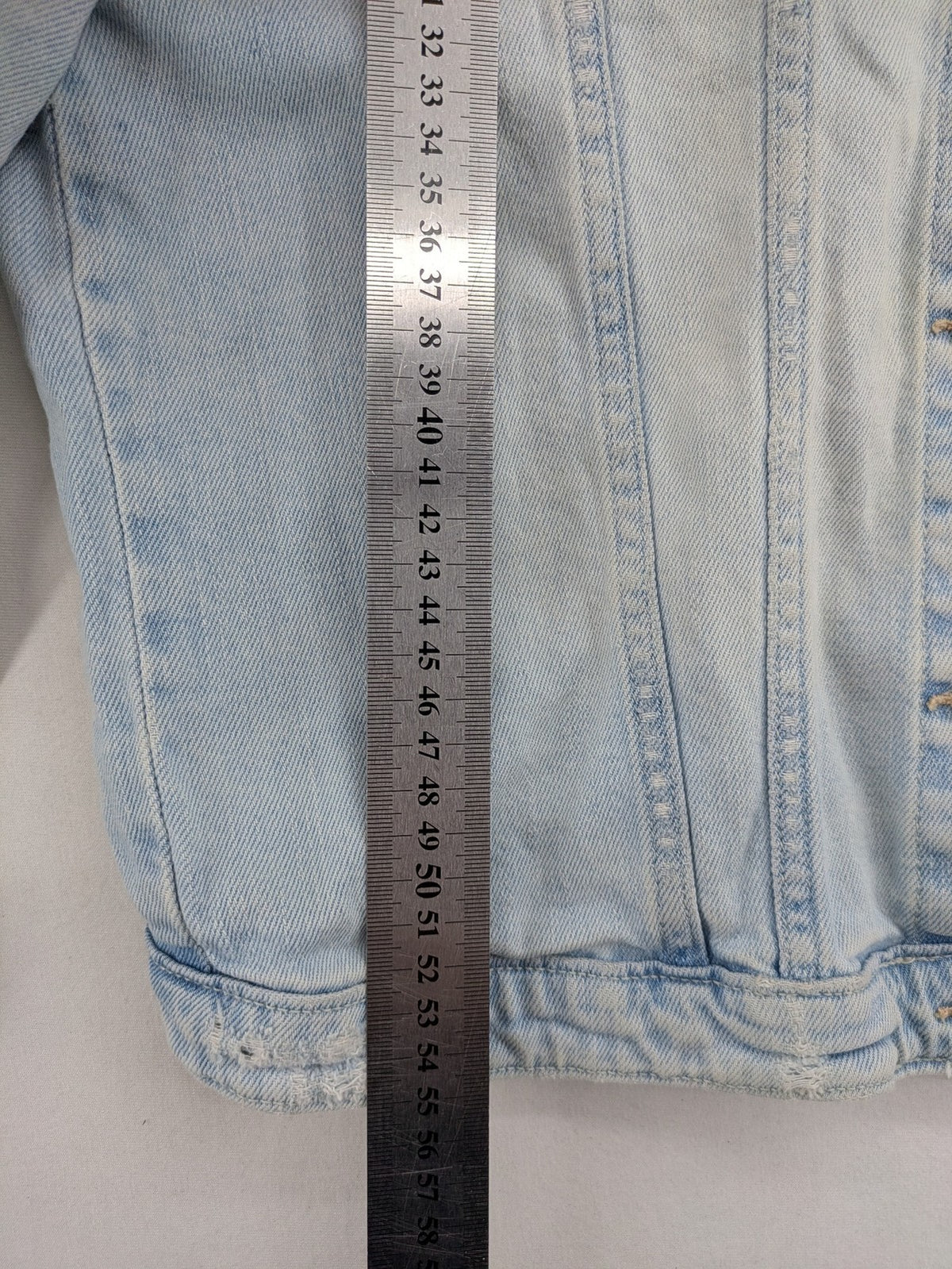 H&M denim jacket light blue classic trucker style with button placket and chest pockets.