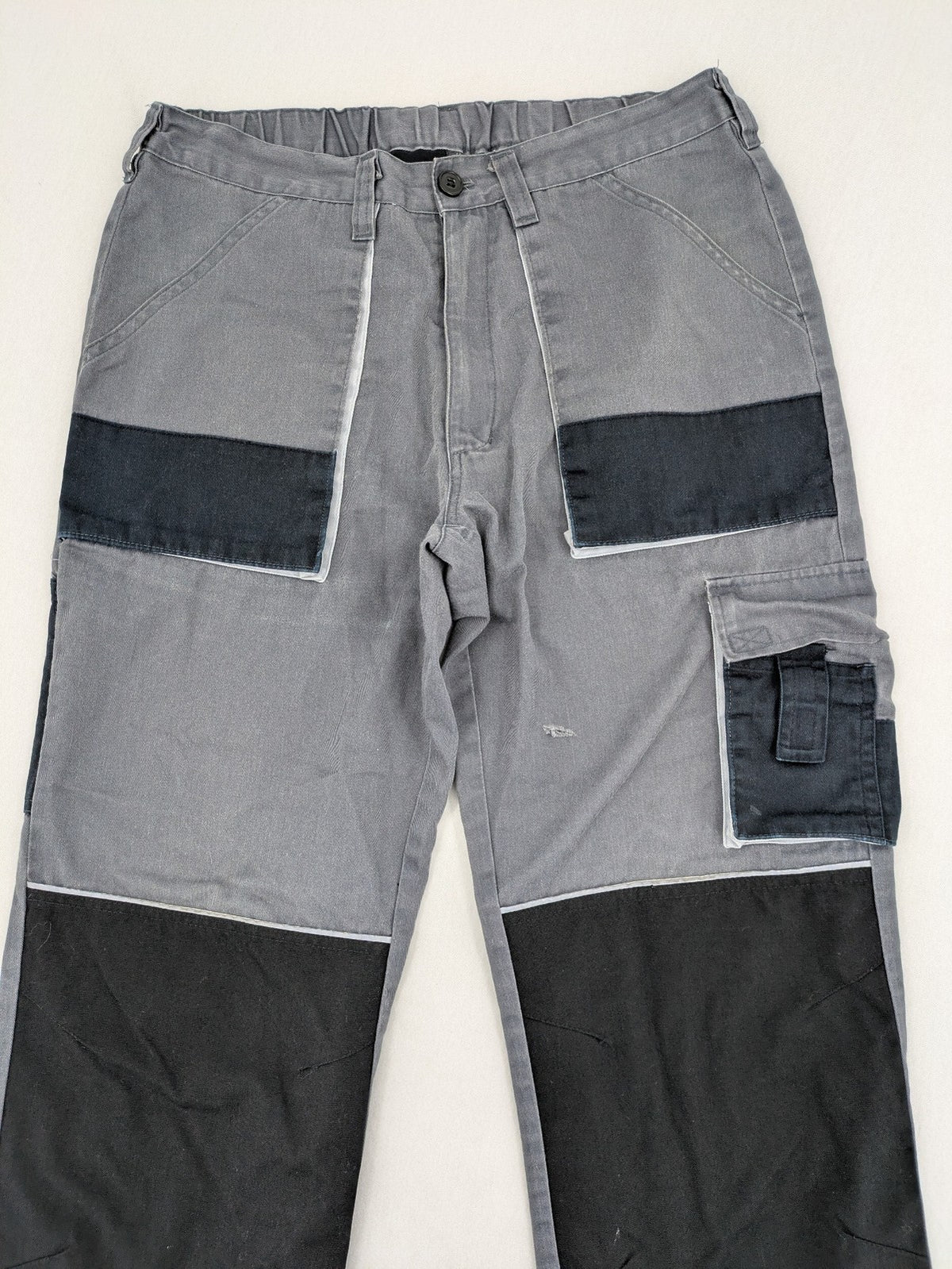Watsons grey and black hunting tactical pants with Cordura reinforcements and elastic waistband.