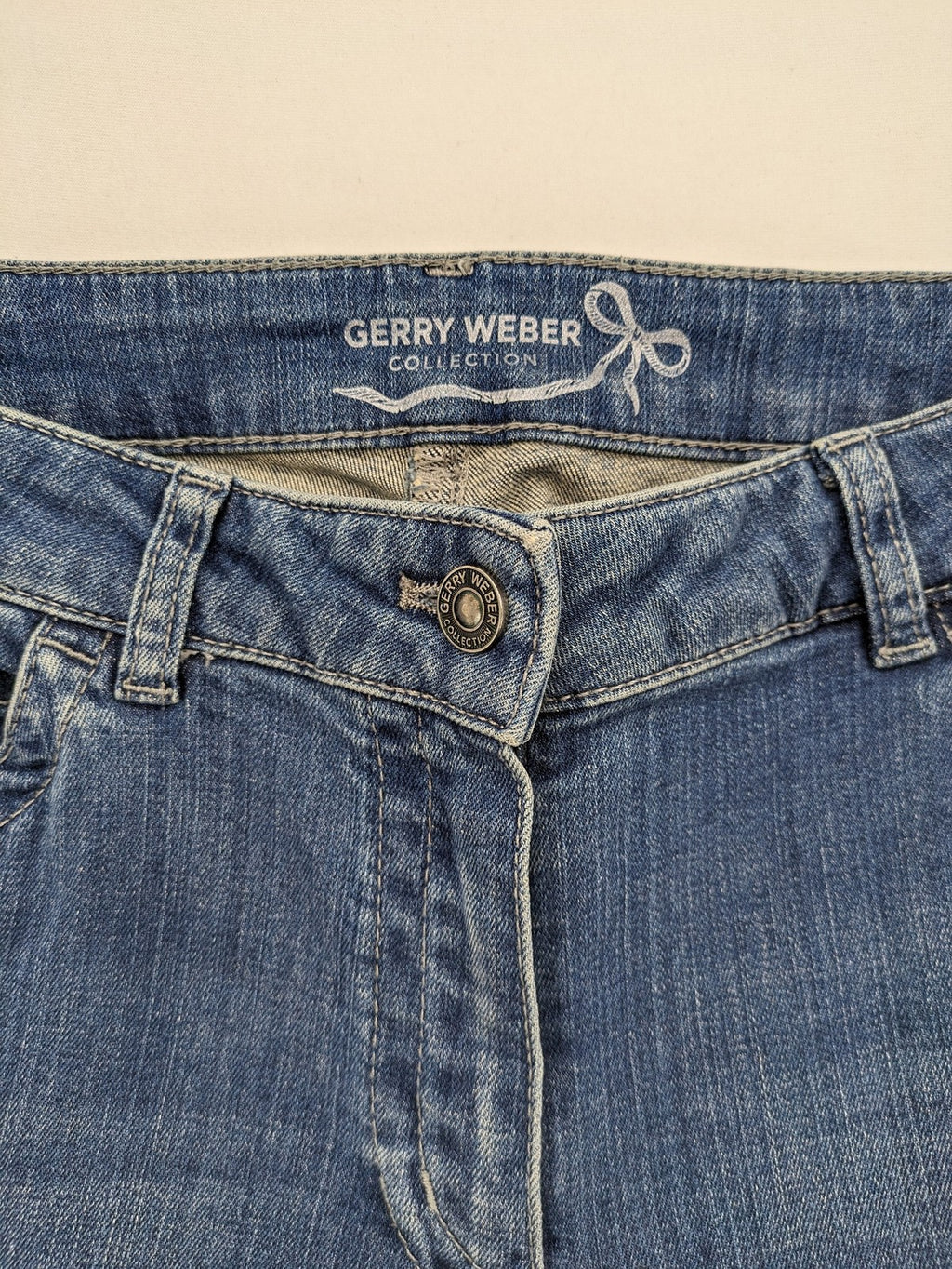 Gerry Weber blue straight jeans with decorative rhinestone appliqués and stretch denim material.