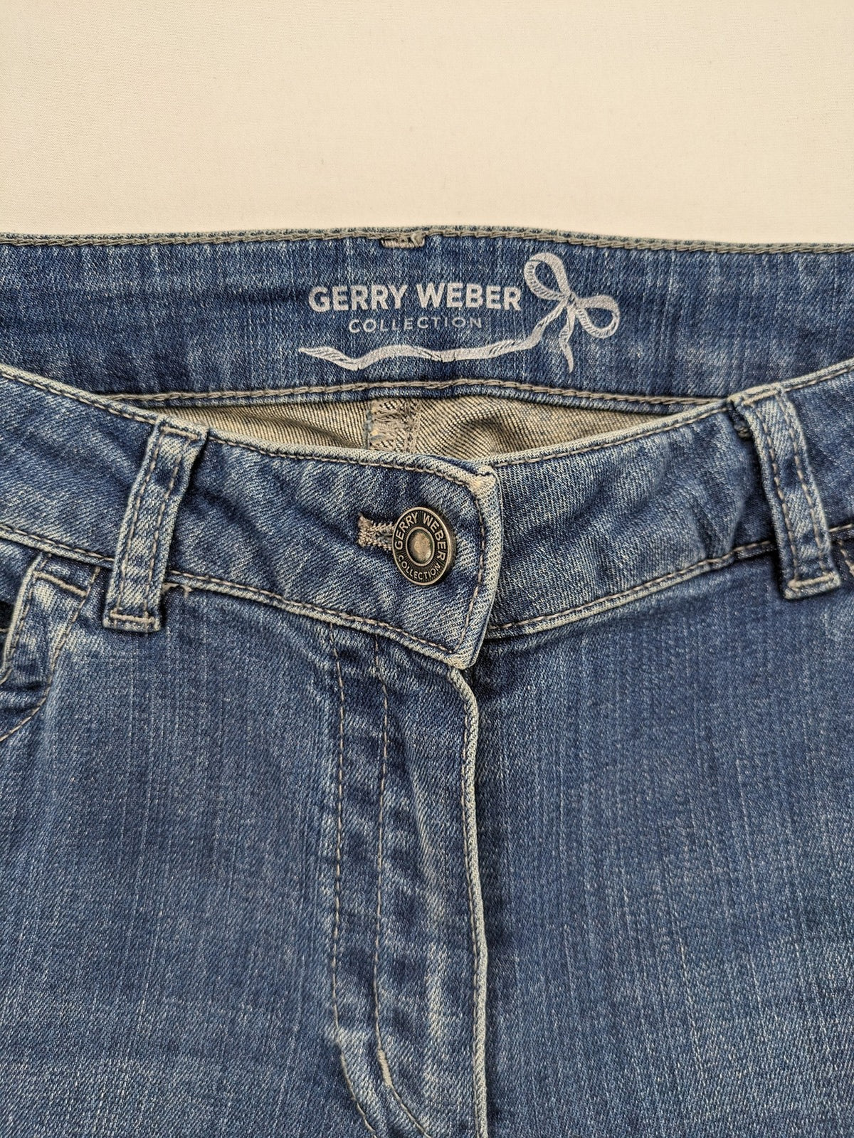 Gerry Weber blue straight jeans with decorative rhinestone appliqués and stretch denim material.