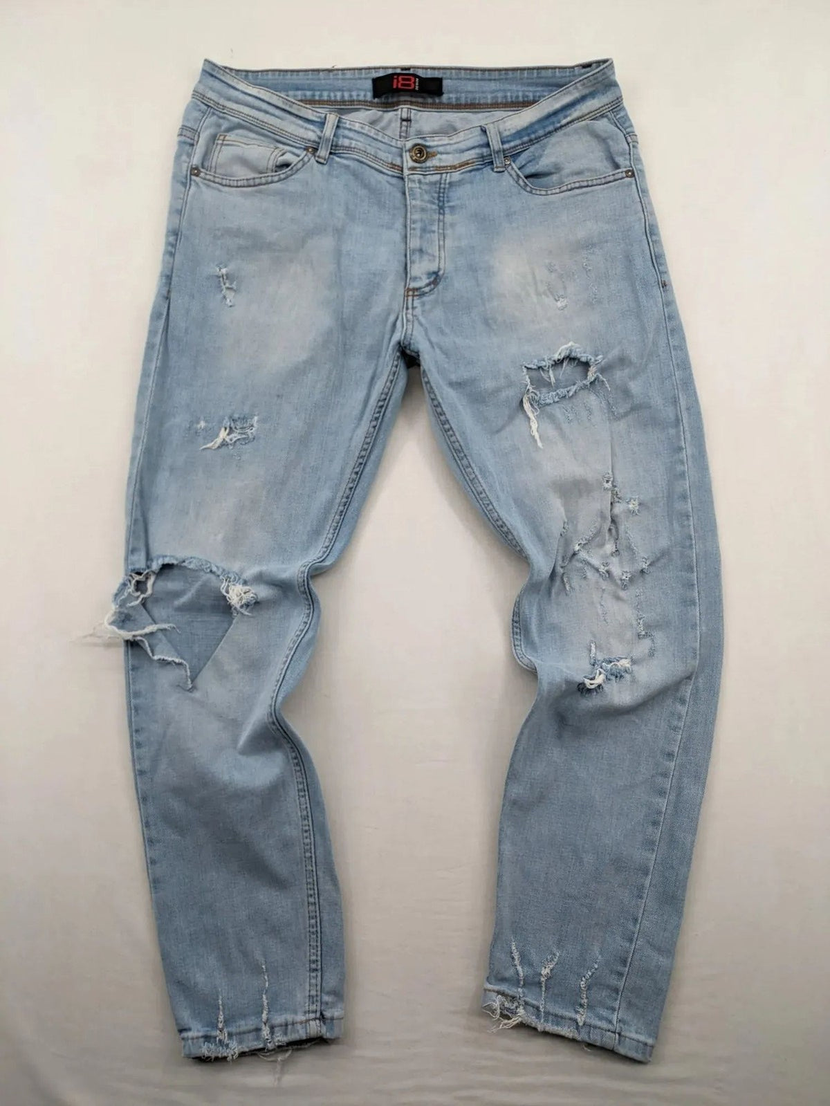 i8 Denim blue straight jeans destroyed look with frayed hems and classic button fly.
