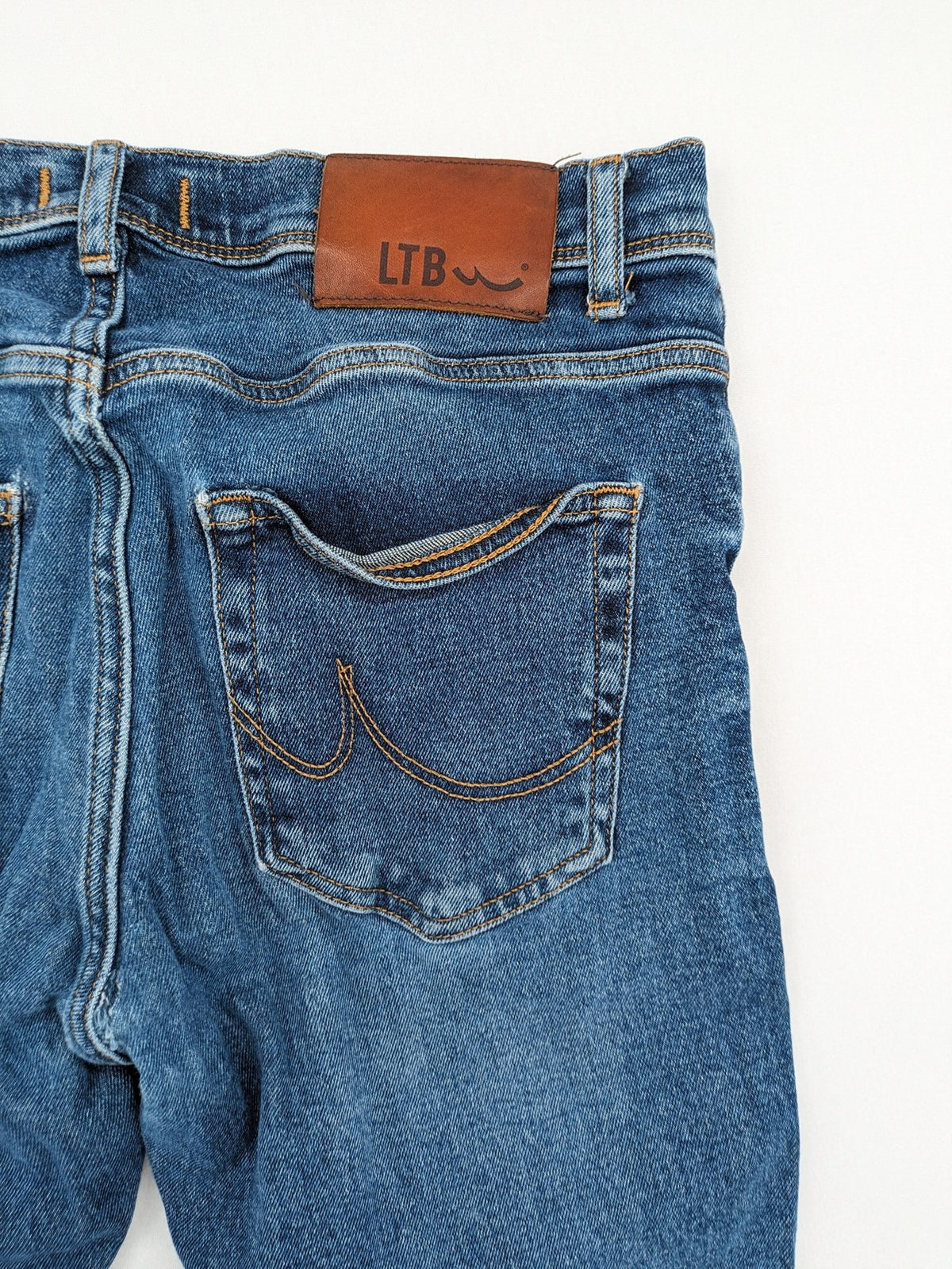 LTB blue straight jeans with low rise, button fly, and classic denim wash.