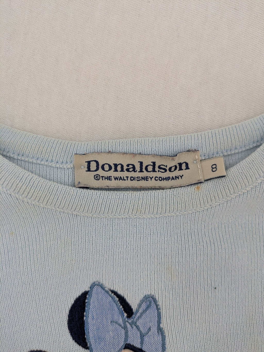 Donaldson multi turtle neck jumper light blue with embroidered Minnie Mouse graphic and ribbed texture.